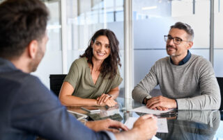 Couple meeting with a franchise attorney before investing in their franchise business.