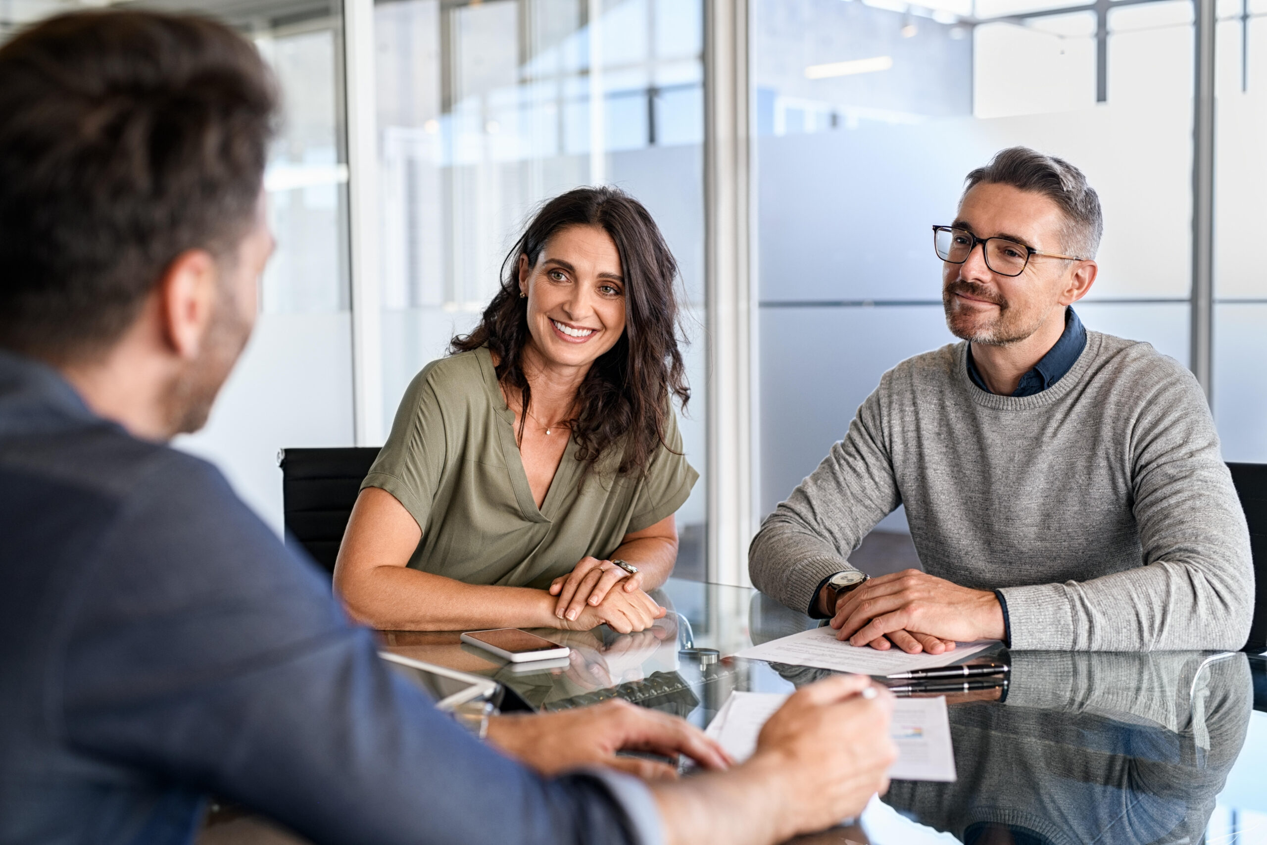 Couple meeting with a franchise attorney before investing in their franchise business.